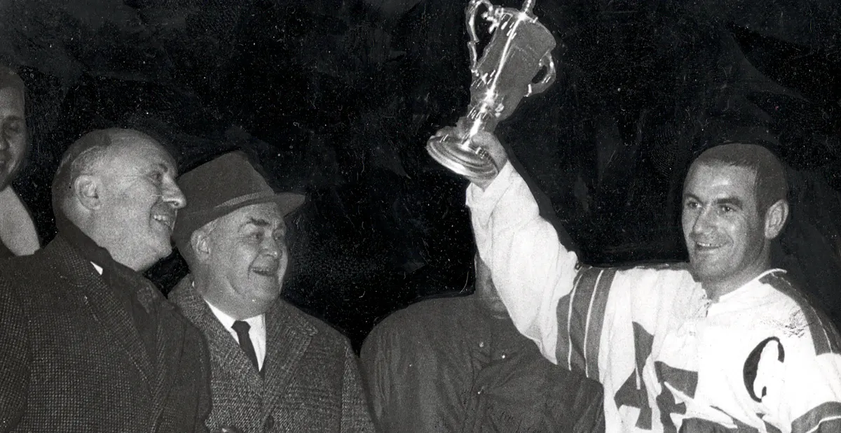 Ein histtorisches Bild von Paul Ambros wie er einen Pokal hoch hält