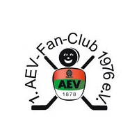  Eine Art Strichmännchen: Zwei Eishockeyschläger sind überkreuzt, so dass die Schaufel des Schlägers die Beine, die Griffe die Hände darstellen soll. Der Bauch besteht aus dem AEV-Logo. Darüber als Gesicht ein Puck mit Smiley 